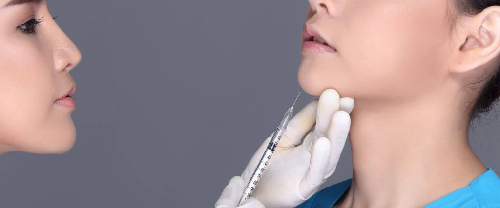 Female dentist injecting woman with botox for dental, oral, and facial conditions